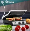 A close-up shot of a panini press with sandwiches inside, along with fresh ingredients like lettuce and tomatoes. Anteprima dell’immagine prodotto