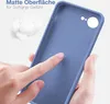 A hand is touching a blue phone case, highlighting its matte texture. Produktbild-Vorschau