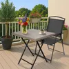 A small square table with a vase of flowers and a cup of coffee on a balcony. Produktbild-Vorschau