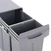 A close-up view of a gray, built-in trash can with two compartments, showing the sliding mechanism and the handle of one of the bins. Produktbild-Vorschau