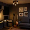 A music studio setup with a desk, keyboard, guitar, microphone, amplifier, and sofa. Produktbild-Vorschau