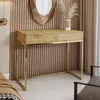A modern console table with a wooden top and gold metal legs, set against a textured wall and next to a chair. Produktbild-Vorschau