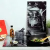 A kitchen counter scene with a cutting board, a mortar and pestle, a bottle of oil, a book, and a frying pan with vegetables. Podgląd zdjęcia produktu