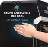 A hand is shown touching the side of a black air fryer, highlighting its cool-touch feature. Produktbild-Vorschau
