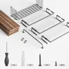 A flat lay of a disassembled shelf unit with its components and hardware laid out on a white background. Produktbild-Vorschau