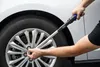 A person is using a torque wrench to tighten a lug nut on a car wheel. Anteprima dell’immagine prodotto