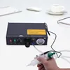 A semi-automatic glue dispenser is shown on a white desk with office supplies in the background. Náhled obrázku produktu