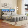 A modern bedroom with a grey upholstered bed featuring LED lighting and storage. The room has decorative wall art and curtains. Náhled obrázku produktu