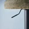 Close-up of a bar stool's height adjustment lever and seat. Produktbild-Vorschau