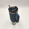 A blue insulated tumbler with a straw and lid, placed on a white surface. Produktbild-Vorschau