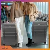 Two women standing in an airport terminal with luggage. Náhled obrázku produktu