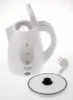 A white electric kettle with its lid open, shown on a white background. The kettle has water level indicators and the brand name 'ADLER' is visible. The power cord and plug are also visible to the right of the kettle, and the lid is placed separately in th Voir les images du produit