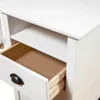 Close-up view of an open drawer and shelf on a white wooden desk. Podgląd zdjęcia produktu