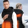 A man and a woman are shown wearing black heated vests with orange heating elements visible. Náhľad obrázku produktu