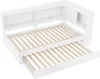 A white daybed with a pull-out trundle and built-in shelving unit. Voir les images du produit
