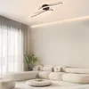 A modern living room with a sectional sofa, coffee table, and a ceiling light. Voir les images du produit