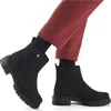 A person wearing black boots and red pants. Produktbild-Vorschau