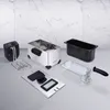 A collection of deep fryer components laid out on a light gray surface with a white marble-patterned wall in the background. Produktbild-Vorschau