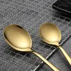Two golden spoons are placed on a metal grid. Anteprima dell’immagine prodotto