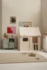 A child's play tent set up in a room with toys and artwork. Produktbild-Vorschau