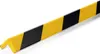 A close-up, angled view of a yellow and black striped corner protector profile against a white background. Náhled obrázku produktu