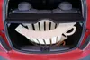 A wooden climbing arch is packed in the trunk of a red car. Produktbild-Vorschau