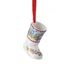 A ceramic Christmas boot ornament with a festive winter scene painted on it, hanging from a red ribbon. Produktbild-Vorschau