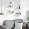 A living room scene with shelves mounted on the wall above a sofa. Produktbild-Vorschau