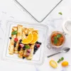 A breakfast spread with crepes, berries, orange slices, and jam. Voir les images du produit
