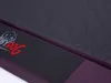 A close-up view of a dog bed, showing the quilted fabric and a branded strap. Produktbild-Vorschau
