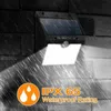 A solar-powered wall light is mounted on a brick wall during a rain shower, with a bright light illuminating the area below. Text overlays highlight its waterproof rating. Voir les images du produit