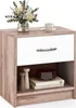 A white and wood-grain nightstand with a drawer and an open shelf, decorated with a vase of flowers and a coffee cup on top. Podgląd zdjęcia produktu