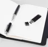 A notebook with a pen and a USB drive on its pages. Náhľad obrázku produktu