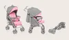 Three views of a pink and gray baby stroller: one fully open, one partially open, and one folded. Produktbild-Vorschau