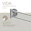 A close-up marketing image of a chrome towel rack with text overlays highlighting its features. Produktbild-Vorschau