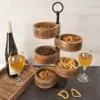 A tiered snack serving platter with various snacks and drinks, set against a white wooden wall. Podgląd zdjęcia produktu