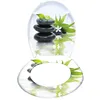 A toilet seat with a spa-like design featuring stacked stones, bamboo leaves, and water reflections. Náhled obrázku produktu