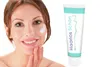 A woman is applying cream to her face next to a tube of the product. Produktbild-Vorschau
