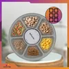 A circular pet food dispenser with multiple compartments filled with different types of pet food, shown on a stand. Anteprima dell’immagine prodotto