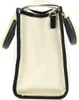 A side view of a beige tote bag with black trim. Anteprima dell’immagine prodotto
