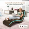 A woman is sitting on a brown floor chair in a living room, using a laptop. Náhľad obrázku produktu