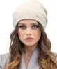 A woman wearing a beanie and coat. Produktbild-Vorschau