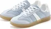 A pair of light blue and white sneakers with tan soles, shown from a diagonal angle against a white background. Produktbild-Vorschau