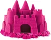 A pink kinetic sand castle on a white background. Voir les images du produit