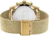 A close-up view of the back of a gold Tommy Hilfiger watch with a mesh band. Voir les images du produit