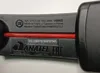A close-up view of the labeling on a black gaming headset, showing serial numbers, model information, and regulatory marks. Produktbild-Vorschau