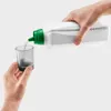 A person is pouring liquid from a white bottle with a green cap into a small gray measuring cup. Produktbild-Vorschau