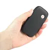 A hand holding a black pager device. Voir les images du produit