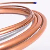 A close-up shot of coiled copper tubing with a blue cap on one end, against a white background. Produktbild-Vorschau