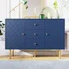 A navy blue dresser with a decorative pattern and gold legs is shown in a well-lit room. Voir les images du produit